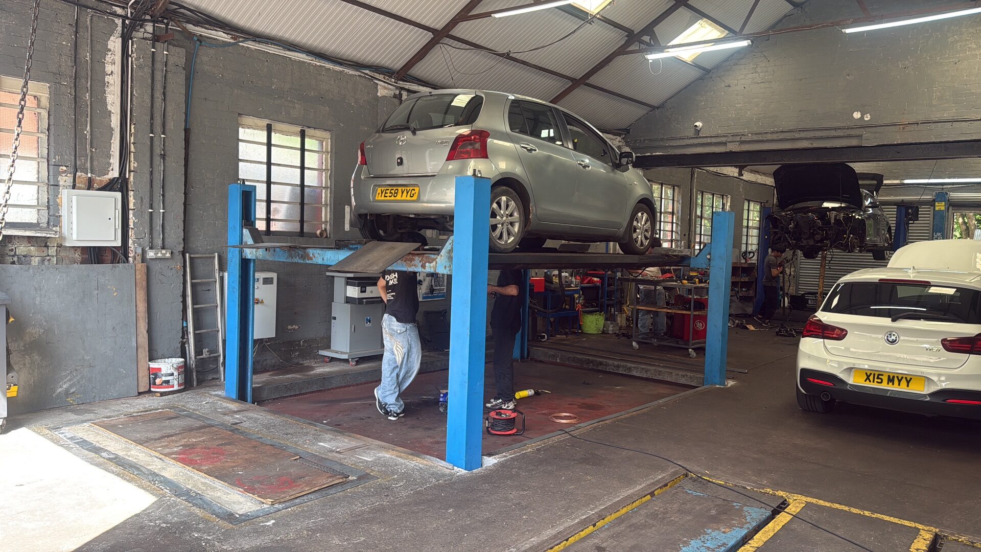 Mechanic carrying out a professional vehicle repair in a workshop